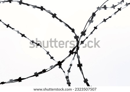 barbed wire on a cloudy sky background, blank for design, background picture, fence made of metal barbed wire