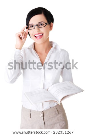 Portrait of woman in eyewear holding a book.