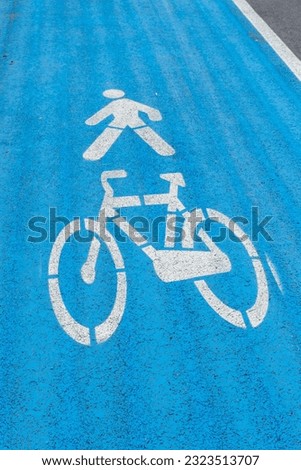 Roadsign for cyclists and pedestrians on asphalt