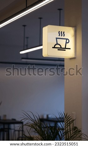 An image of a coffee shop sign in a contemporary building interior Royalty-Free Stock Photo #2323515051