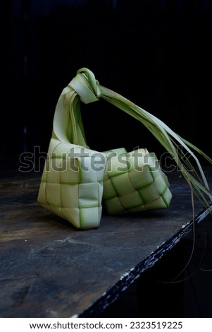 Ketupat skin, made from coconut leaves. Usually filled with raw rice, then boiled for a long time, until it becomes a mature ketupat. Royalty-Free Stock Photo #2323519225