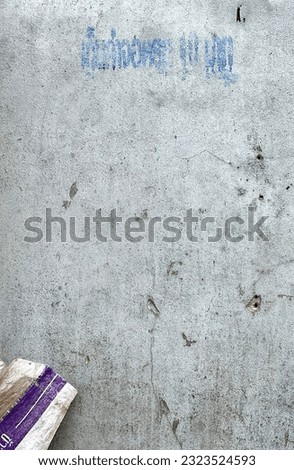 a photography of a sign on a concrete wall that says welcome to you, there is a sign on the wall that says welcome to us