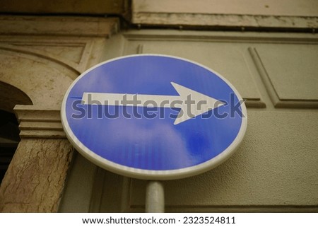 A low angle shot of a one way sign