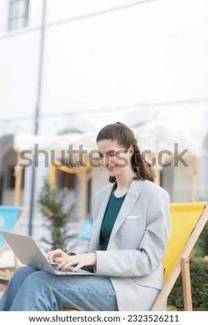 Young Adult Woman Using Laptop and Digital Tablet for Business Communication, Internet, and Wireless Technology.