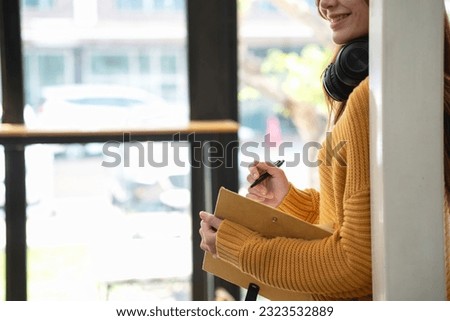 Happy latin girl college student watching distance online learning class, remote university webinar or having talk on laptop video call and use notebook to virtual meeting seminar at home or campus