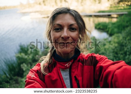 Happy cyclist taking selfie in front of nature. High quality photo
