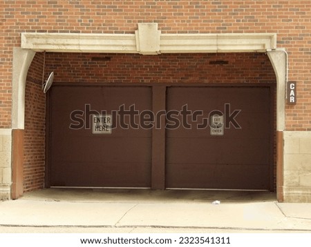 a garage for cars with "entrance" and "exit" symbols on gates