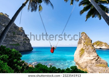 Young woman tourist on Bali swing at Diamond beach at Nusa Penida island Bali ,Indonesia Royalty-Free Stock Photo #2323541913