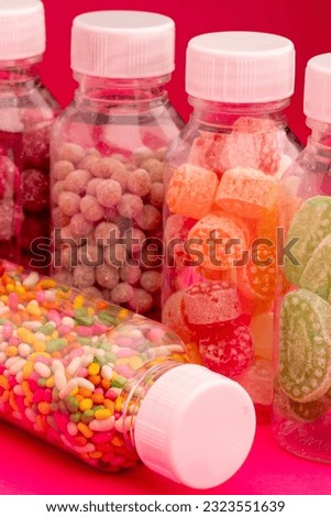 Colourful lollipops and different coloured round candy.
