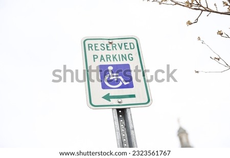 The blue handicap sign on the street - a universal symbol for accessibility and mobility aid for individuals with disabilities