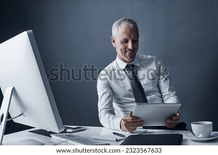 Tablet, accountant and elderly business man in studio isolated on a dark background mockup space. Technology, happy and manager at desk, executive or auditor working on research, email or reading app