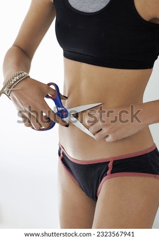 Scissors, stomach and woman with anorexia in studio for mental health, crisis or problem on white background. Weight loss, cutting and slimming female with body dysmorphia, bulimia or eating disorder Royalty-Free Stock Photo #2323567941