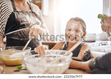 Portrait, playing or messy kid baking in kitchen with a young girl smiling with flour on a dirty face at home. Smile, happy or parent cooking or teaching a fun daughter to bake for child development Royalty-Free Stock Photo #2323567977