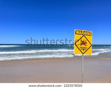 A beautiful shot of a symbol of warning about danger near the sea