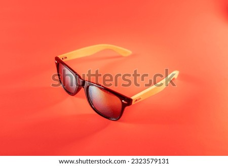 sunglasses for leisure and travel on a red background. High quality photo