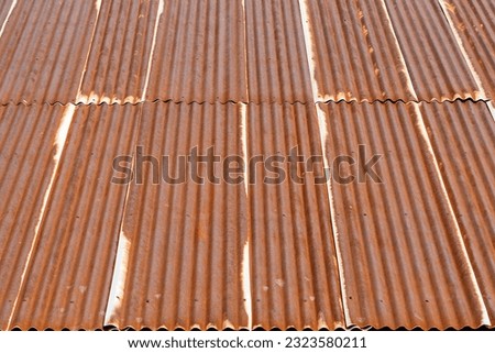 Artistic of old and rusty zinc sheet roof. Vintage style metal sheet roof texture. Pattern of old metal sheet. Rusting metal or siding. Corrosion of galvanized. Background and texture in retro concept