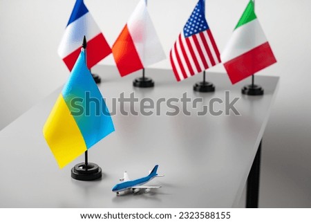 Flags and toy airplane close up. Travel concept