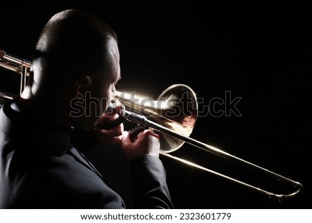 Trombone player. Trombonist playing brass instrument. Man playing jazz trumpet  Royalty-Free Stock Photo #2323601779