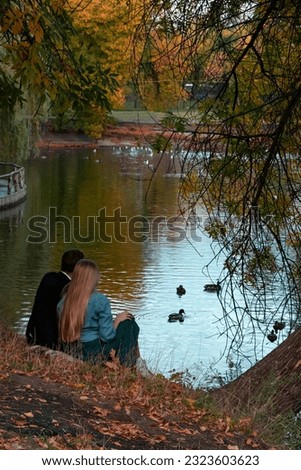 A couple in love is sitting by the lake