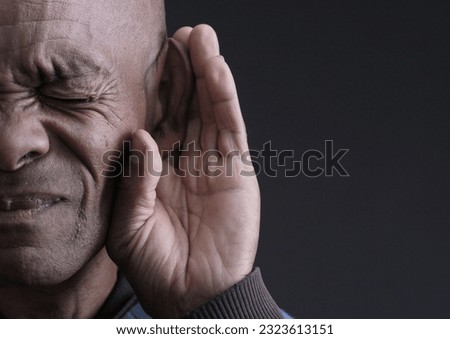 deafness and hearing loss on grey background with people stock photo