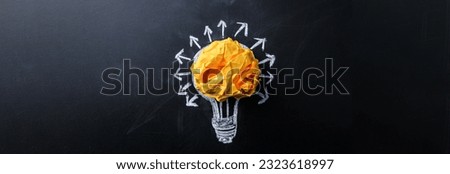 paper with bulb on the black board

