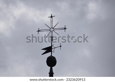 weather vane on top of the bell tower Royalty-Free Stock Photo #2323620913