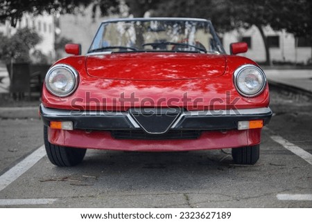 A frontal photo of an red Italian roadster car  Royalty-Free Stock Photo #2323627189