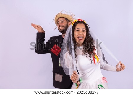 Brazilian couple wearing traditional clothes for Festa Junina dancing