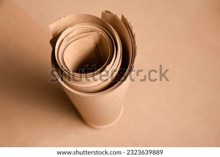 Kraft paper twisted into a roll, top view, close up. Kraft brown ecological paper for packaging, for advertising printing or for household needs, copy space