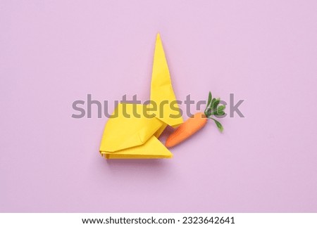 Plastic miniature carrot on a green background. Minimal, conceptual still life, creative layout