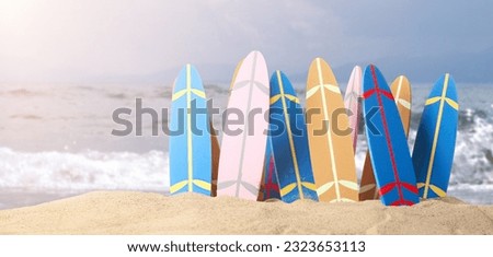 Many small surfboards on beach sand  