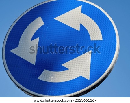 New circle blue roundabout traffic sign  with blue sky