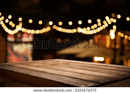 empty wooden brown table on blurred light gold bokeh cafe restaurant bar, place for your products on the table. Abstract background
