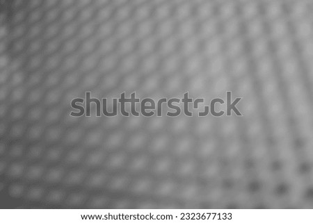 blurred Steel mesh. grey metal screen texture.  Grille background.  blur Artistic Holes. defocused image. 