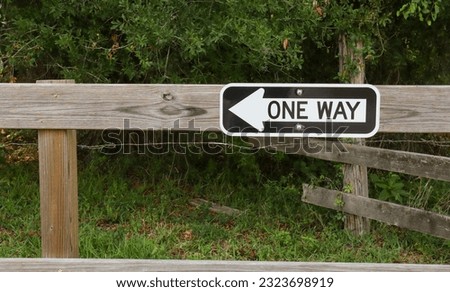One way sign on fencepost