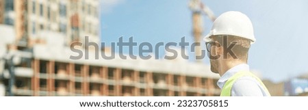 Young civil engineer wearing helmet inspecting building site, engineering and architecture concept Royalty-Free Stock Photo #2323705815