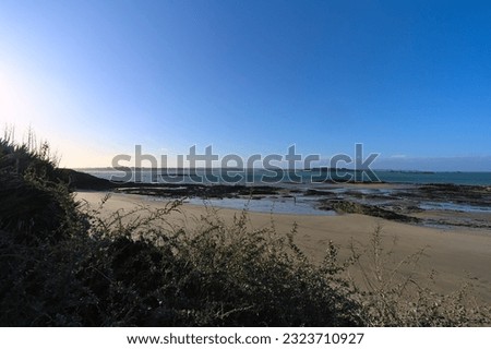View of the deserted beach of Lancieux during low tide a winter sunny afternoon (Briattany, north of France)