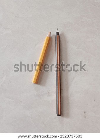 The pen and yellow pencil Royalty-Free Stock Photo #2323737503