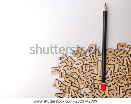 Top view pencil and wooden word on a white background with copy space.