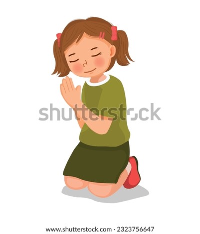 Cute little girl praying kneeling on her knee