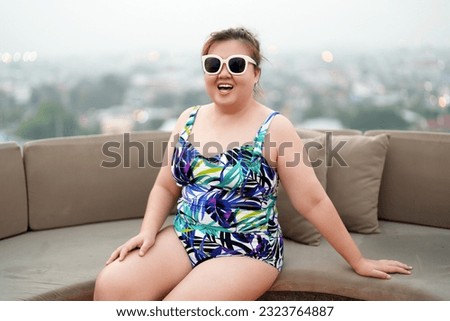 Happy plus size woman Vacation Traveling in summer, Confident overweight asian woman relaxing at pool.
