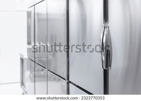 Large commercial refrigerator in closed condition in the kitchen Royalty-Free Stock Photo #2323770353