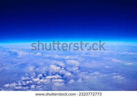 Earth's stratosphere and sunlit sea of clouds Royalty-Free Stock Photo #2323772773