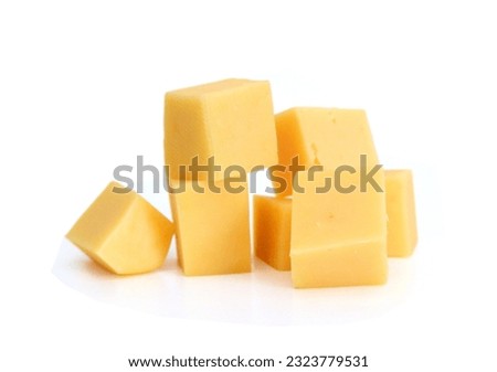 Cubes of cheddar cheese isolated on white  Royalty-Free Stock Photo #2323779531