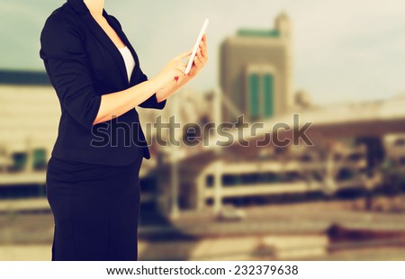 woman in business suit on a city building background. filtered image