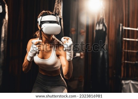 Female boxer training with VR or virtual reality, wearing VR headset with immersive boxing training technique using controller to enhance her skill in boxing simulator. Impetus