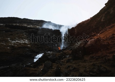 Traveler at FossÃ¡ waterfall in the Faroe Islands