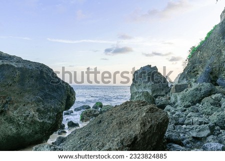 View of coral rocks next to sea waves on the beach under the skyline on a beautiful afternoon at Pandawa Beach, Bali, Indonesia, Bali tourism