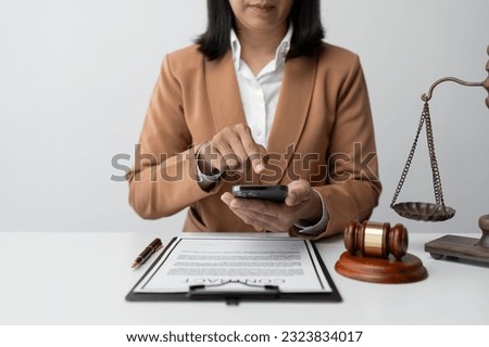 Businesswoman, lawyer using mobile phone to contact Chat online, use a laptop to check details and look at the information before signing the terms and conditions. business concept justice