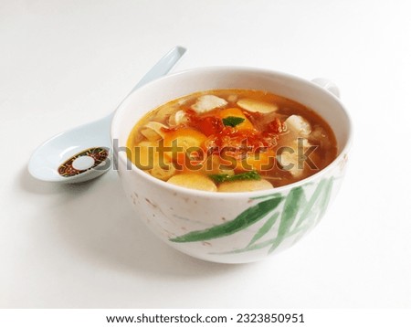 Sop Merah or Sup Merah, Indonesian Tomato Soup, literally translated as Red Soup, is a very popular dish in Indonesia. Made from tomato juice, vegetables, minced chicken and sausage. White background.